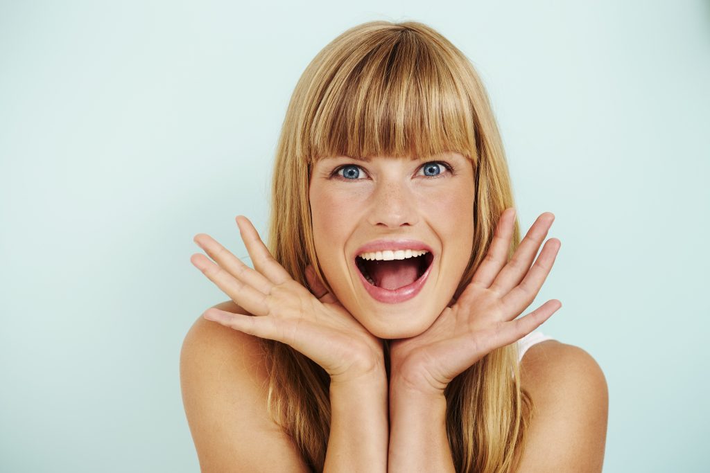 Studio 1 model with curtain bangs smiling